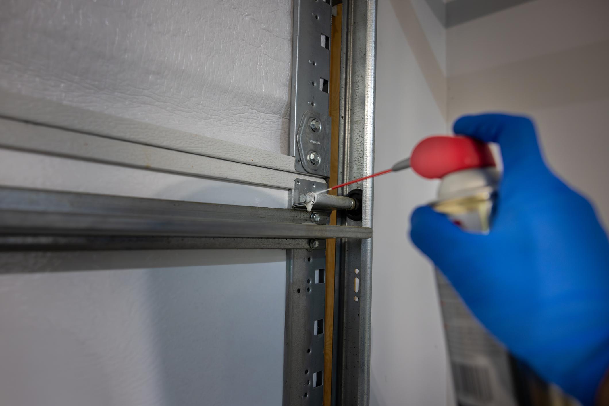 Garage door opener repair technician working on residential system