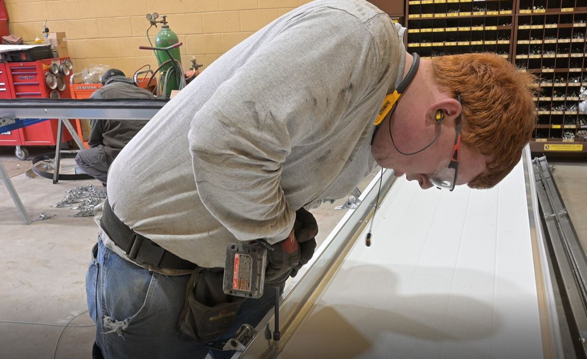 Quality Overhead Door technician working on a garage door in Pocatello Idaho