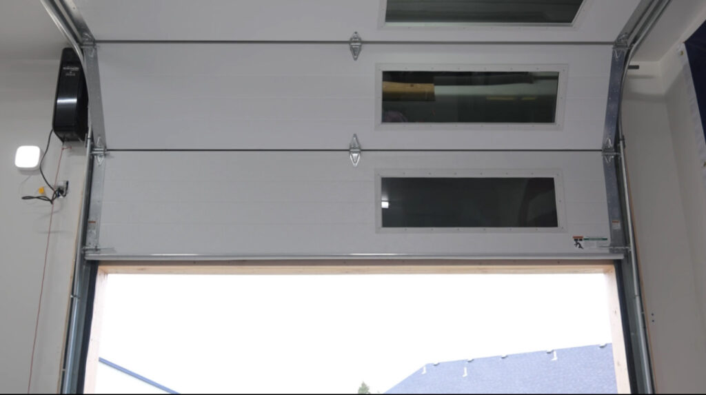 High lift garage door track allowing door to sit closer to ceiling