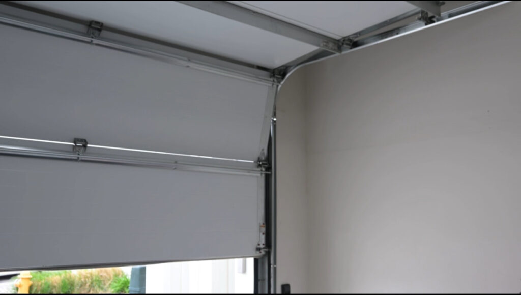 Standard garage door track setup inside residential garage