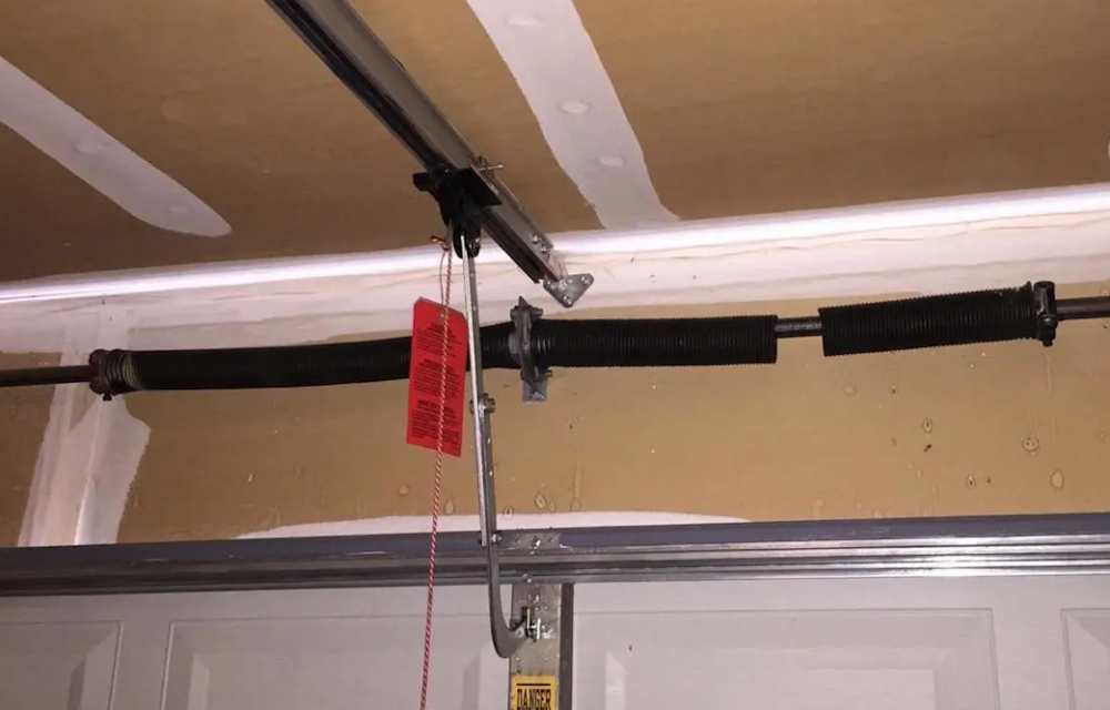 Broken garage door spring requiring professional repair