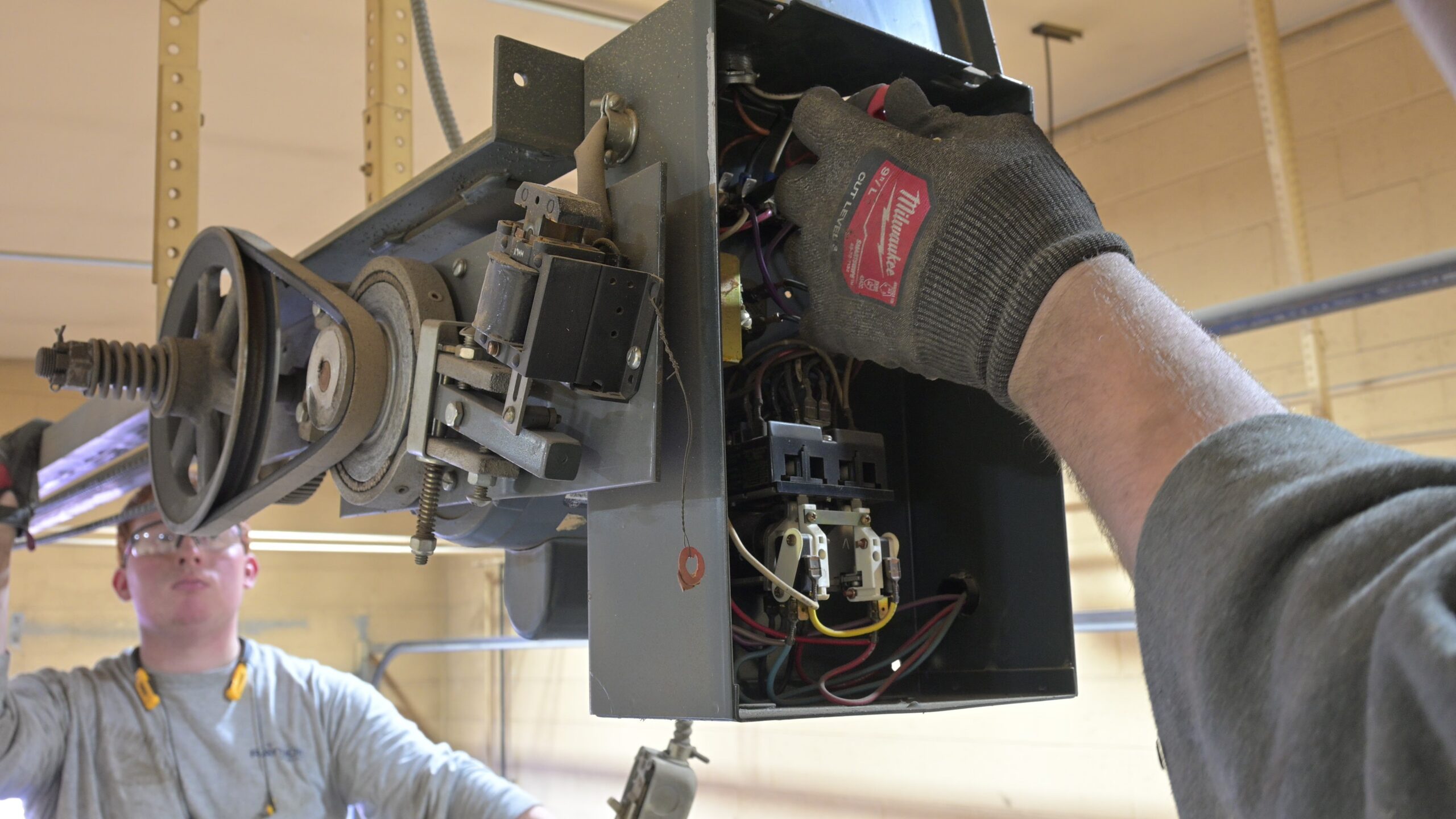 Technician servicing a garage door opener in Southeast Idaho