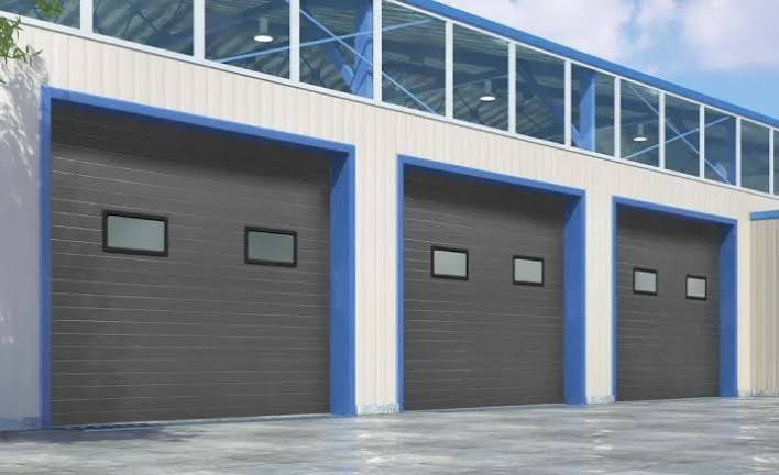 Insulated garage door with decorative windows and residential panel design