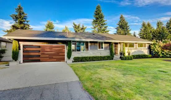Wood garage door installation by Quality Overhead Door